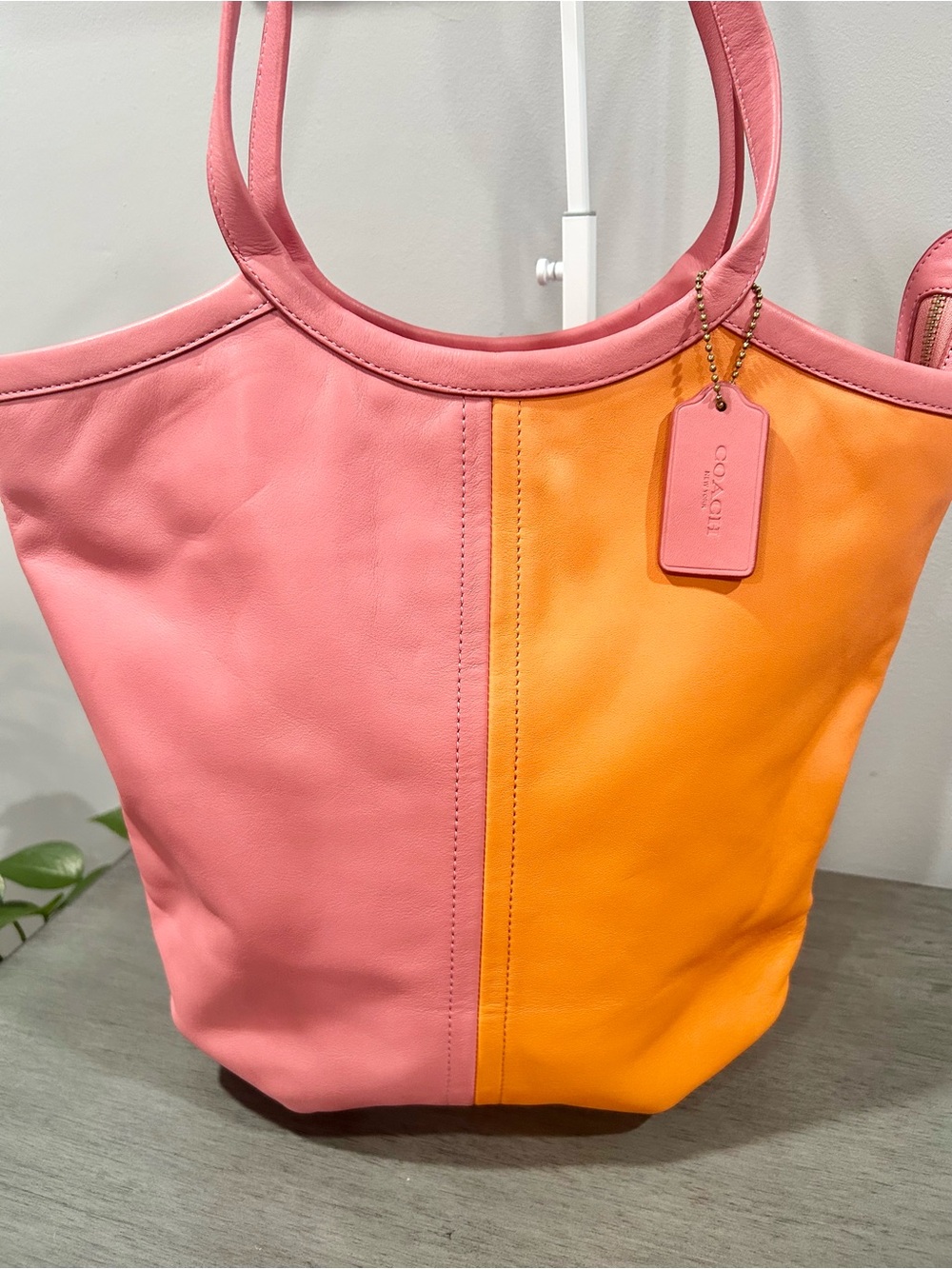 Coach Bea Tote in colorblock taffy pink and orange design.